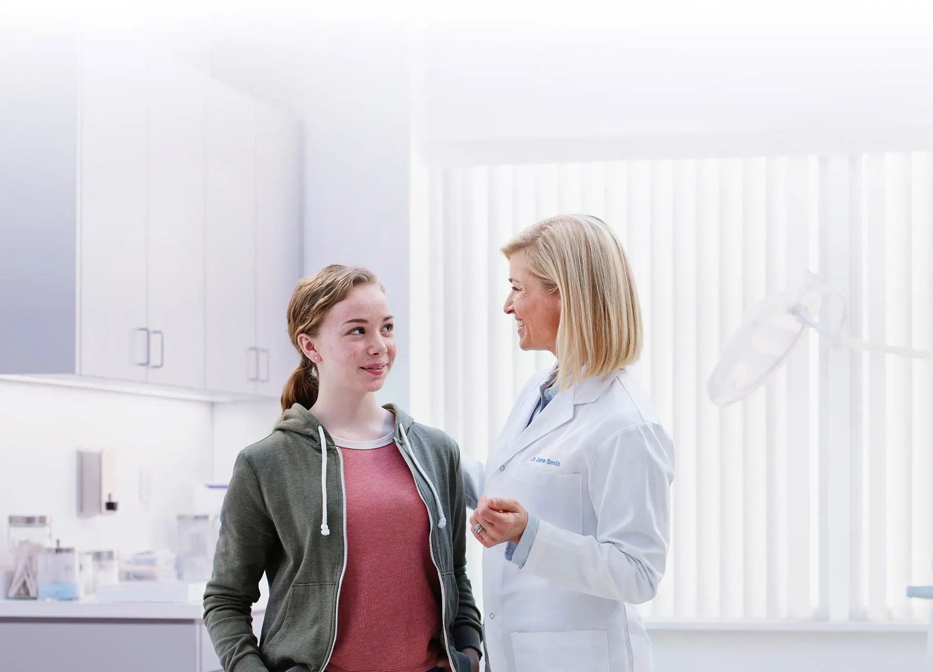 A young woman speaking with a doctor
