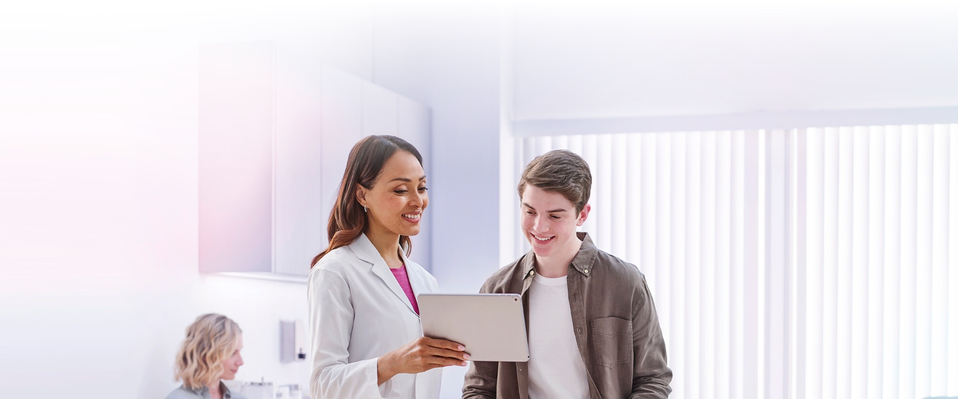 A young man speaking with a doctor