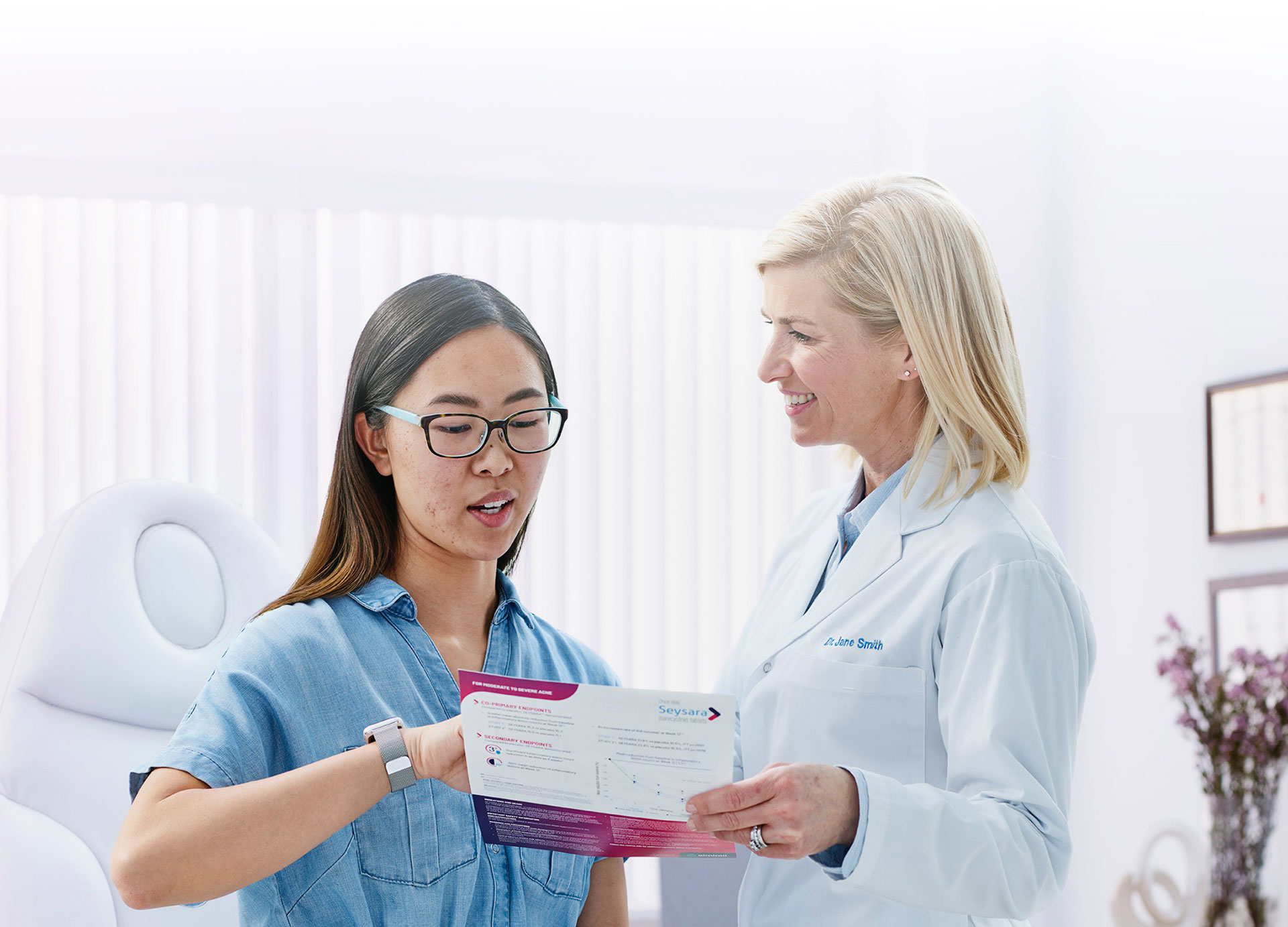 A young woman speaking with a doctor